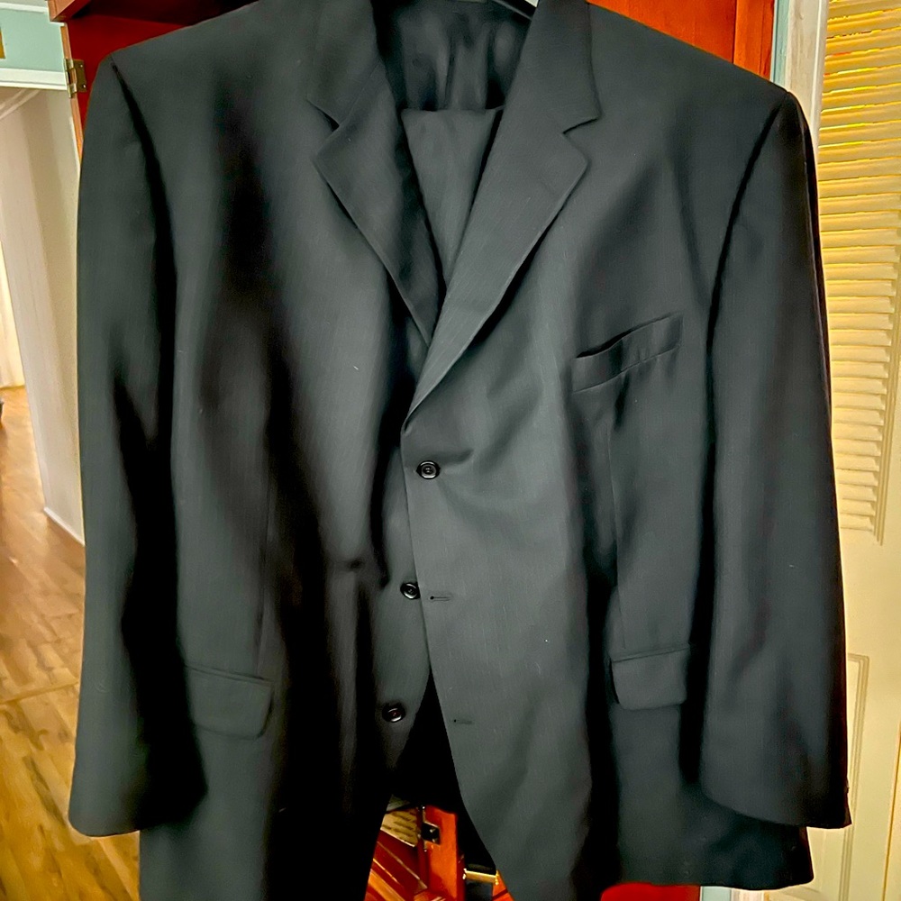 Black pinstripe suit with suspenders.